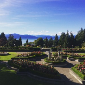 Formal garden with lake and mountains in the background.